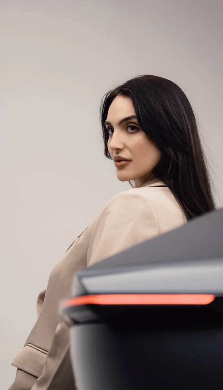 Talent standing beside Tata Avinya rear profile — luxury EV brand storytelling