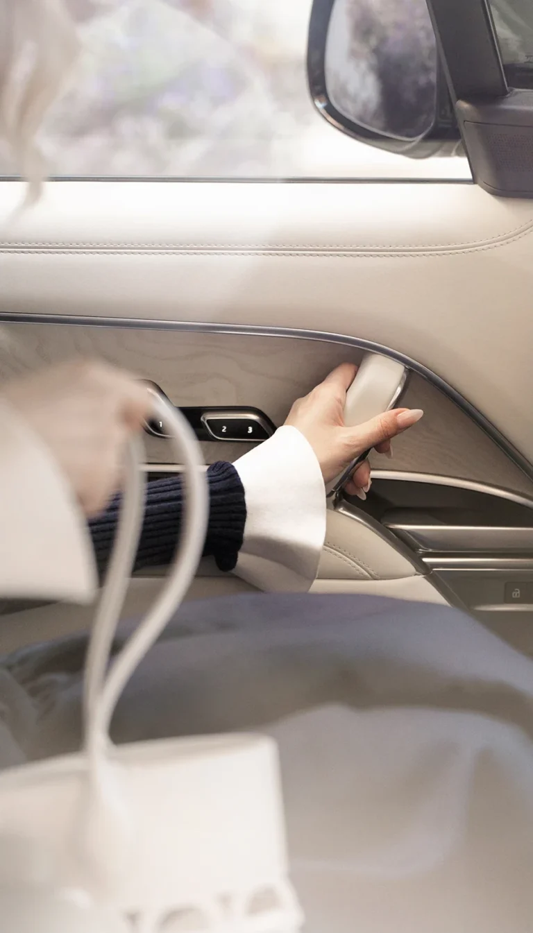 Close-up of hand on Range Rover interior door panel at Wimbledon hospitality
