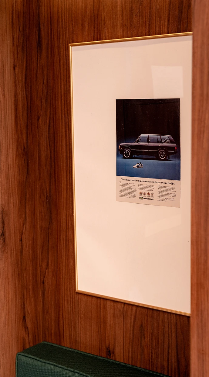 Framed Range Rover heritage print in Wimbledon suite — curated brand storytelling